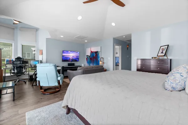 a bed room with furniture and a flat screen tv