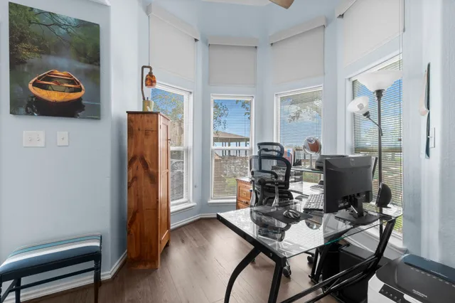 a view of a workspace with furniture and wooden floor