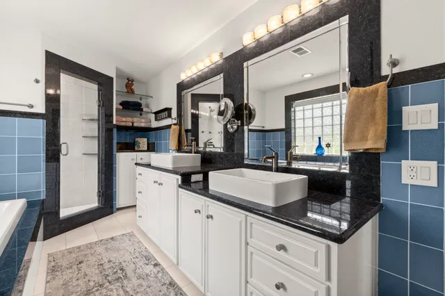 a kitchen with stainless steel appliances granite countertop a sink and a refrigerator