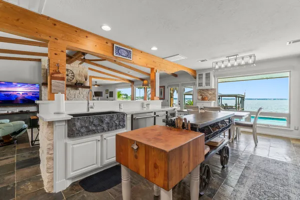 a kitchen with stainless steel appliances granite countertop a stove a sink and a refrigerator