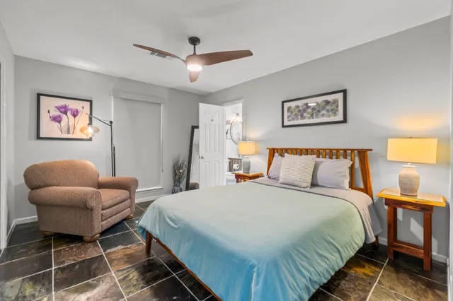 a spacious bedroom with a bed and a couch