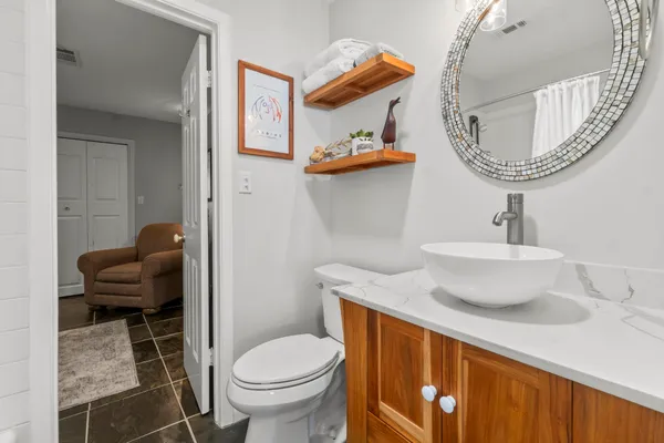 a bathroom with a toilet a sink and a mirror