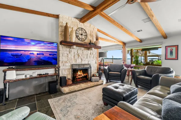 a living room with furniture a flat screen tv and a fireplace