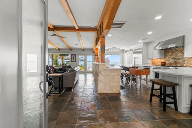 a living room with lots of furniture and kitchen view