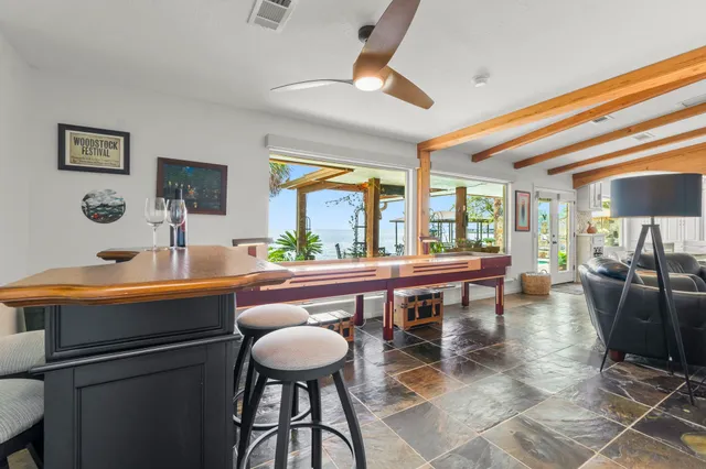 a dining room with furniture a window and a chandelier