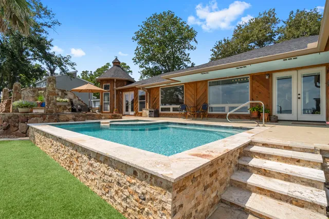 a view of a house with swimming pool and sitting area