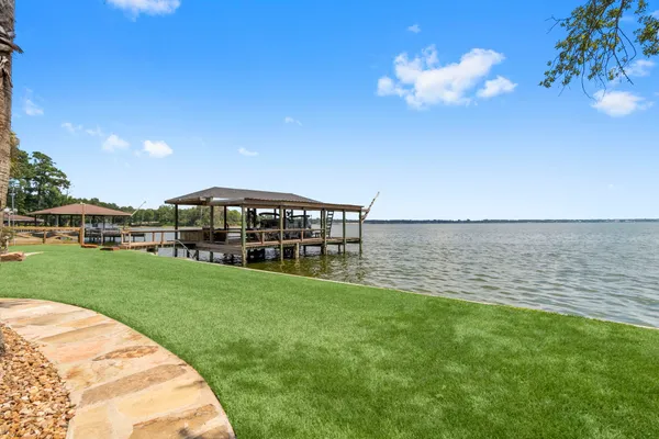 an aerial view of a house with outdoor space pool seating area and yard