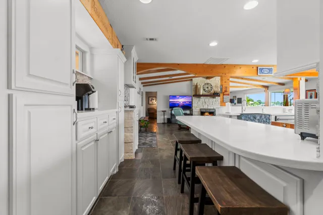 a kitchen with stainless steel appliances kitchen island granite countertop a refrigerator and a stove top oven