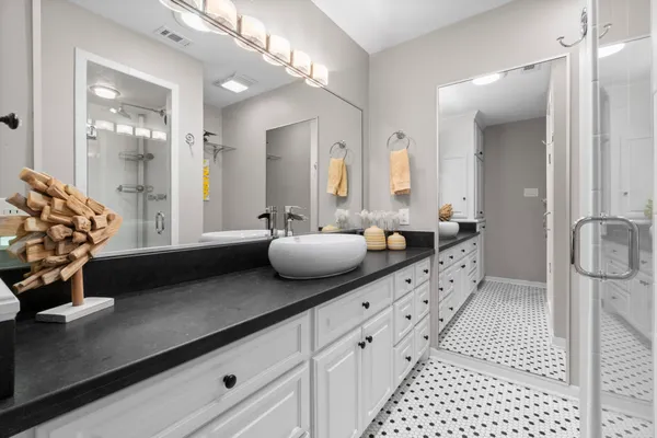 a bathroom with a double vanity sink and mirror