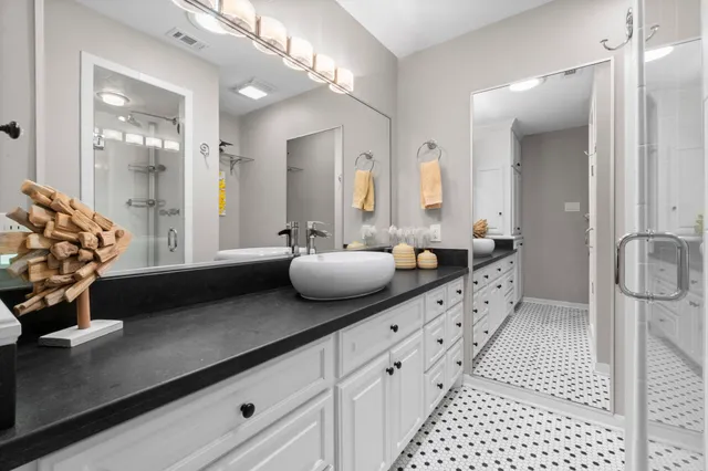a bathroom with a double vanity sink and mirror
