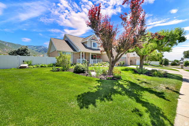4792 Glasmann Way South Ogden, UT 84403 - Photo 5 of 70 Expansive front lawn with mature trees and established landscaping beds with vehicle access to back yard through gate on left
