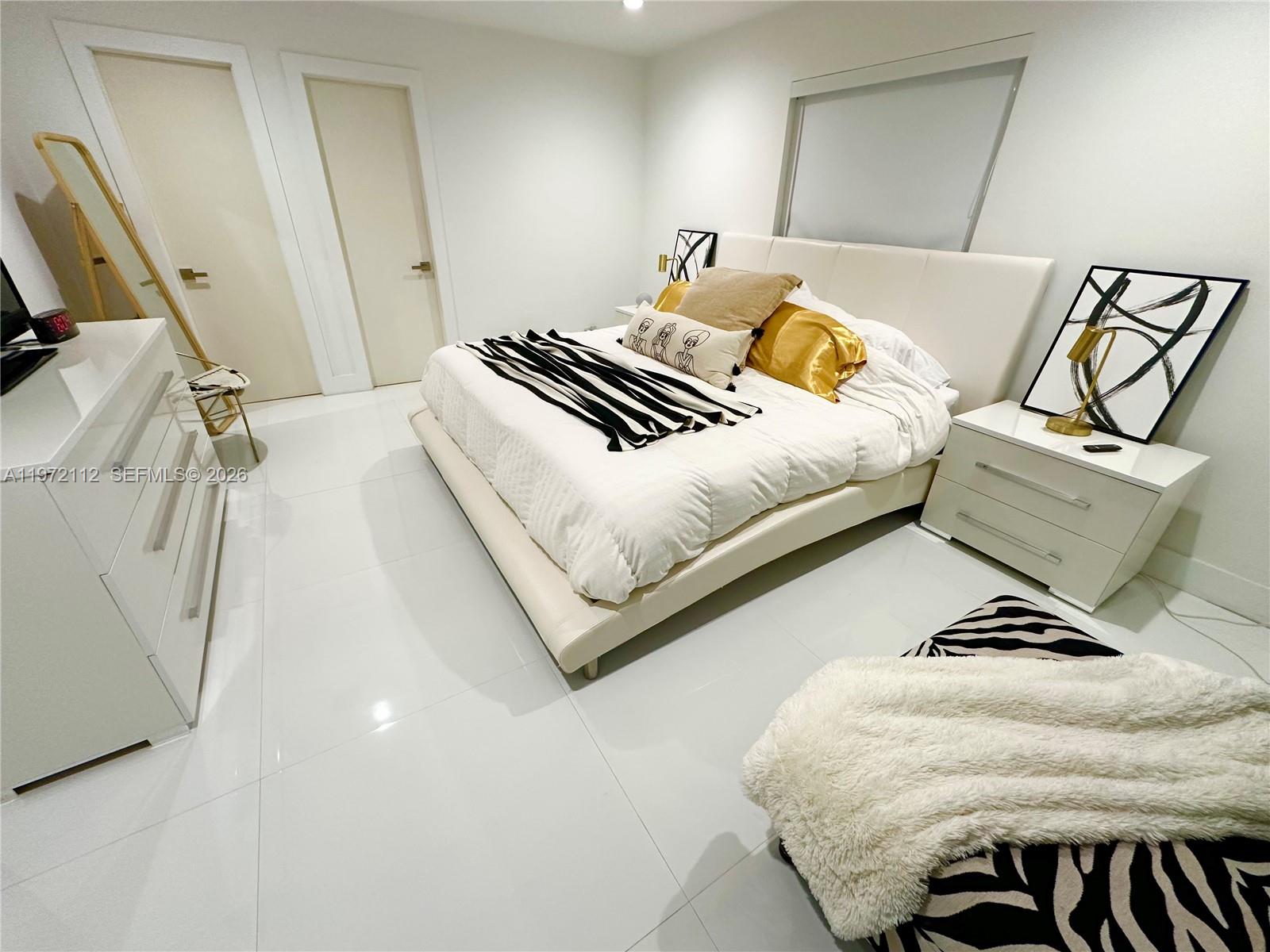 9230 Southwest 68th Street Miami, FL 33173 - Photo 13 of 29 a bedroom with a bed and couch