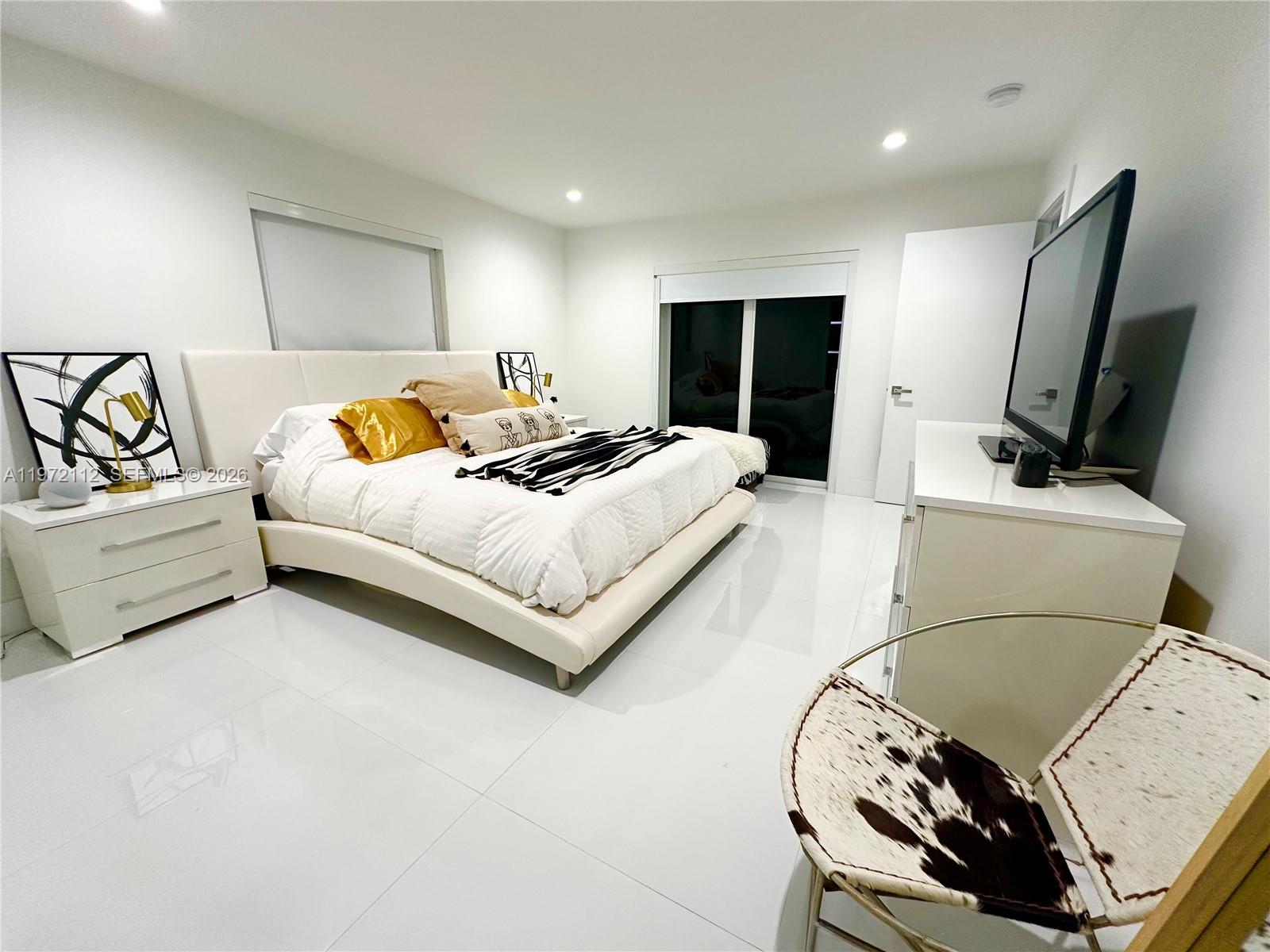 9230 Southwest 68th Street Miami, FL 33173 - Photo 14 of 29 a bedroom with a bed and a flat screen tv