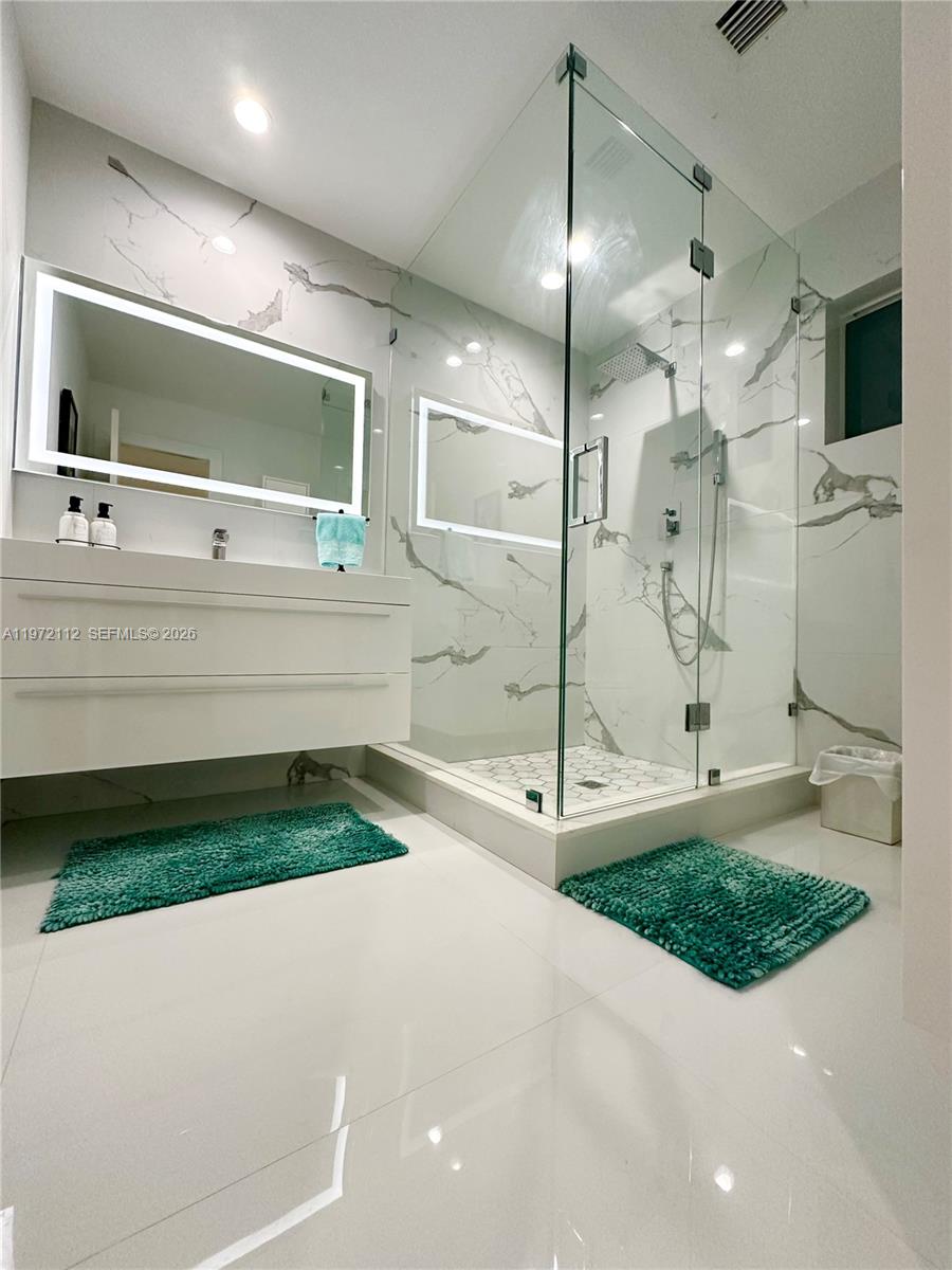 9230 Southwest 68th Street Miami, FL 33173 - Photo 15 of 29 a bathroom with a sink and a large mirror