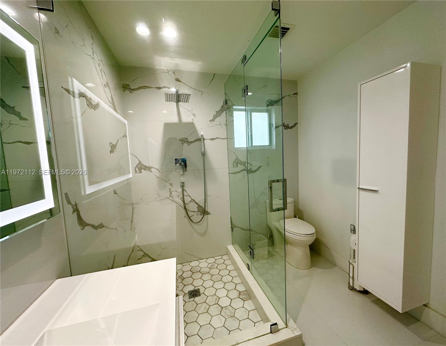 9230 Southwest 68th Street Miami, FL 33173 - Photo 16 of 29 a bathroom with a sink a toilet and shower