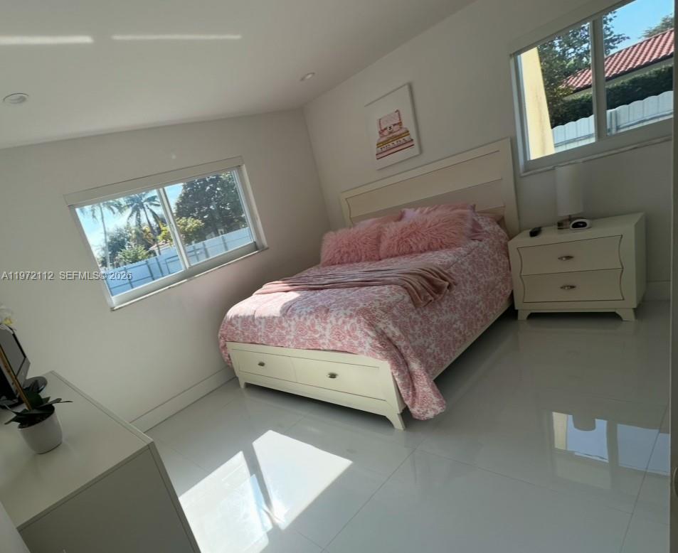 9230 Southwest 68th Street Miami, FL 33173 - Photo 17 of 29 a bedroom with a bed and a dresser