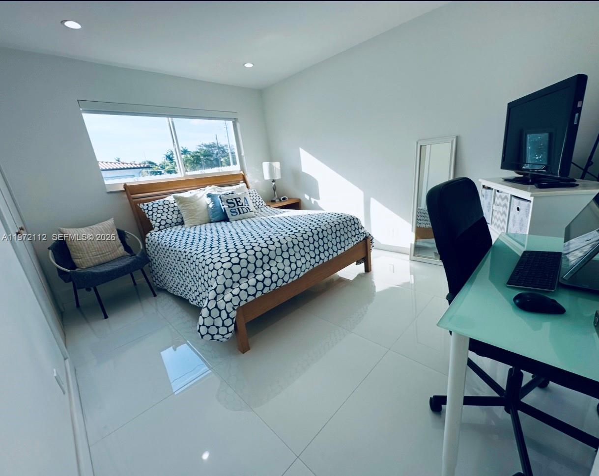 9230 Southwest 68th Street Miami, FL 33173 - Photo 18 of 29 a room with furniture and a flat screen tv