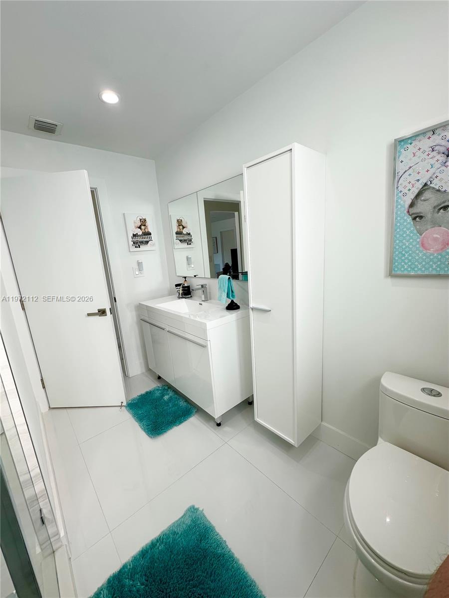9230 Southwest 68th Street Miami, FL 33173 - Photo 19 of 29 a white toilet sitting next to a white sink