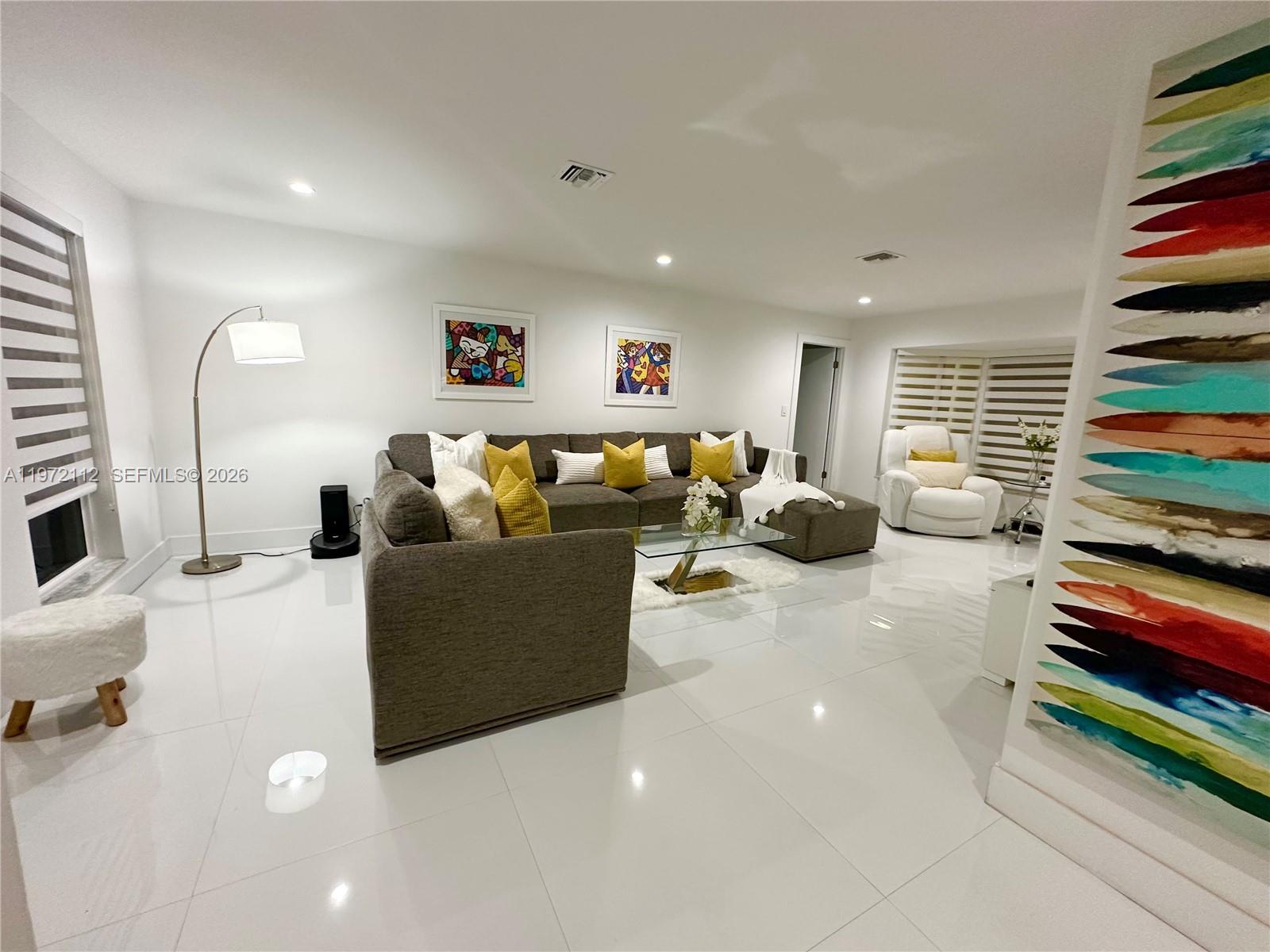 9230 Southwest 68th Street Miami, FL 33173 - Photo 2 of 29 a living room with furniture and a flat screen tv