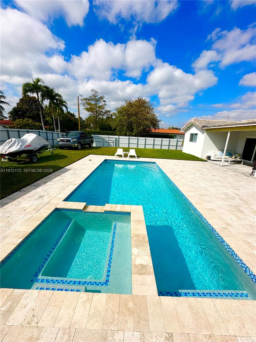 9230 Southwest 68th Street Miami, FL 33173 - Photo 22 of 29 a view of swimming pool with a yard
