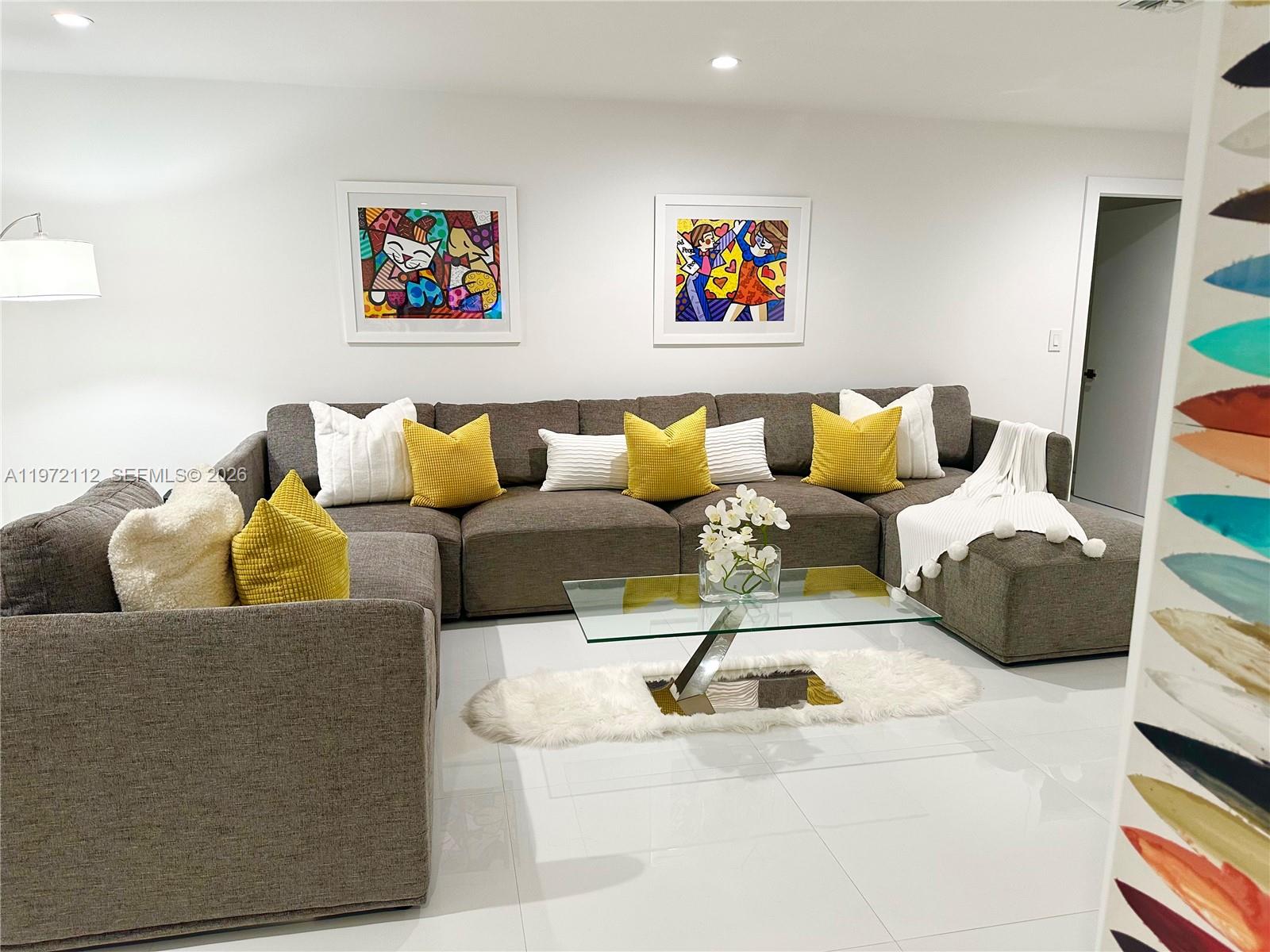 9230 Southwest 68th Street Miami, FL 33173 - Photo 3 of 29 a living room with couches and a painting on the wall