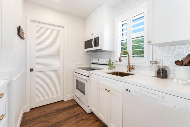 a kitchen with a sink cabinets and a window