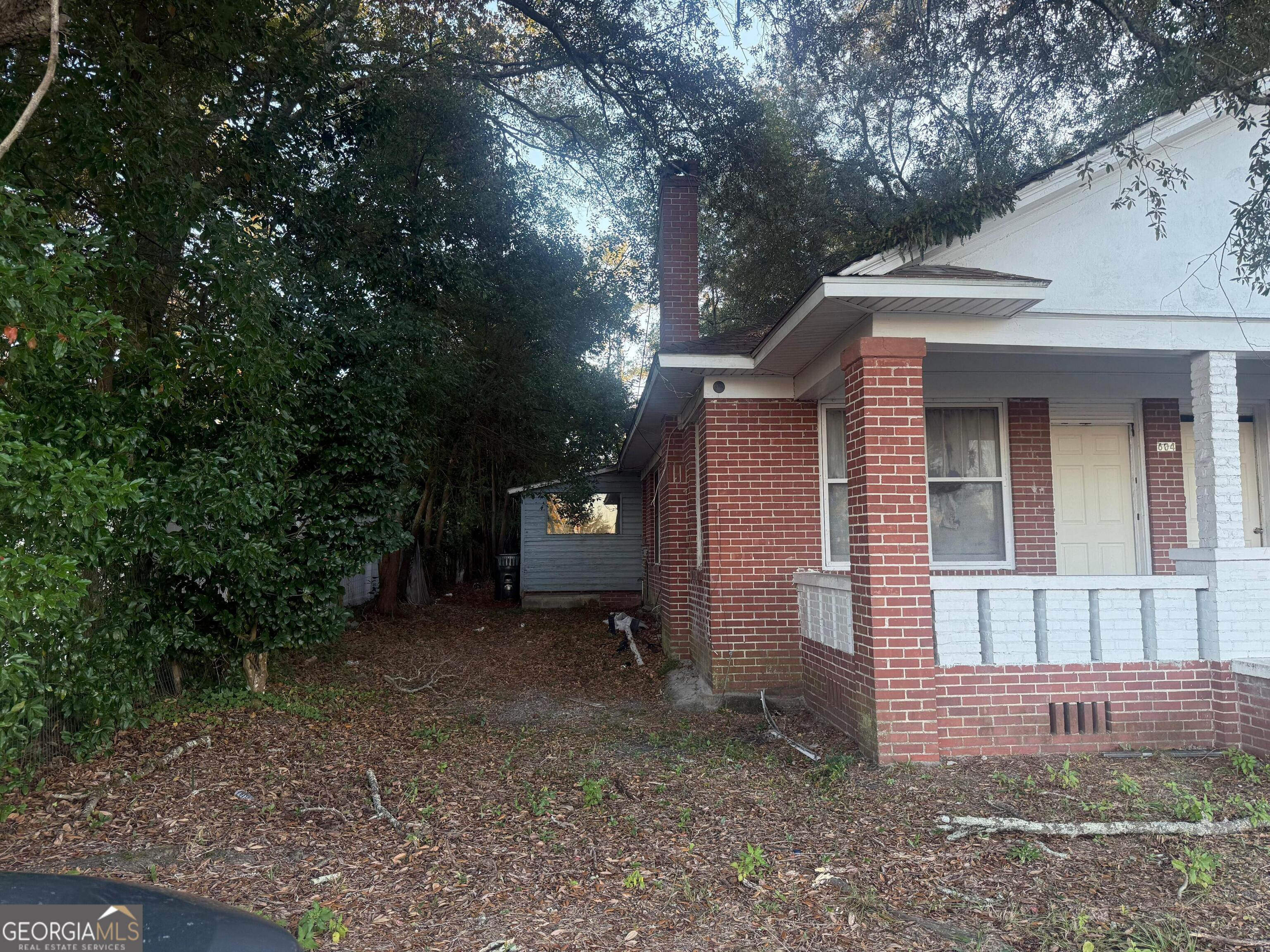 604 Hicks Street Waycross, GA 31501 - Photo 6 of 10 a view of a house with a yard and tree