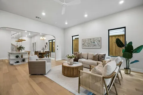 a living room with furniture and wooden floor