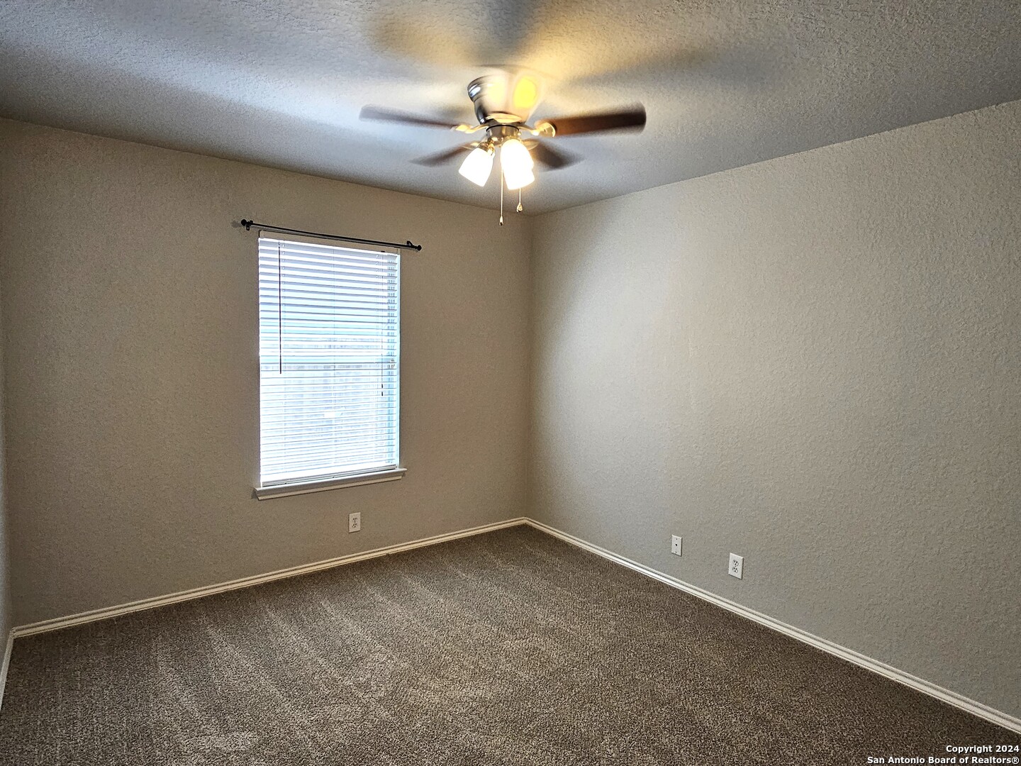 3321 Whisper Bluff Schertz, TX 78108 - Photo 13 of 17 an empty room with a window and a ceiling fan