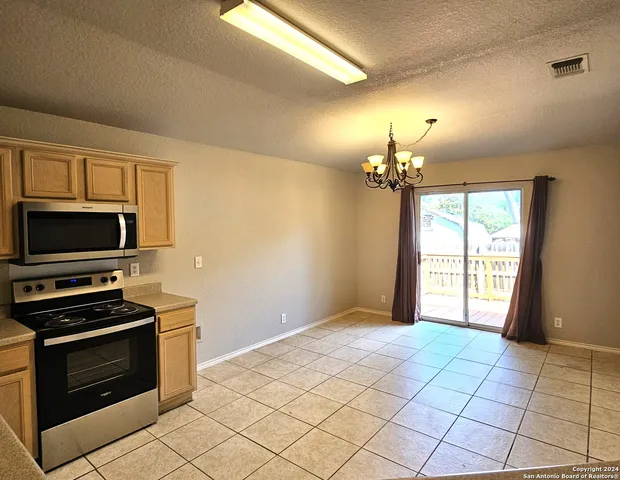 a view of a kitchen with a stove cabinets and a kitchen