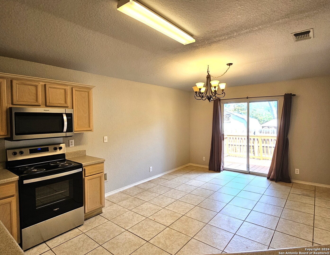3321 Whisper Bluff Schertz, TX 78108 - Photo 4 of 17 a view of a kitchen with a stove cabinets and a kitchen