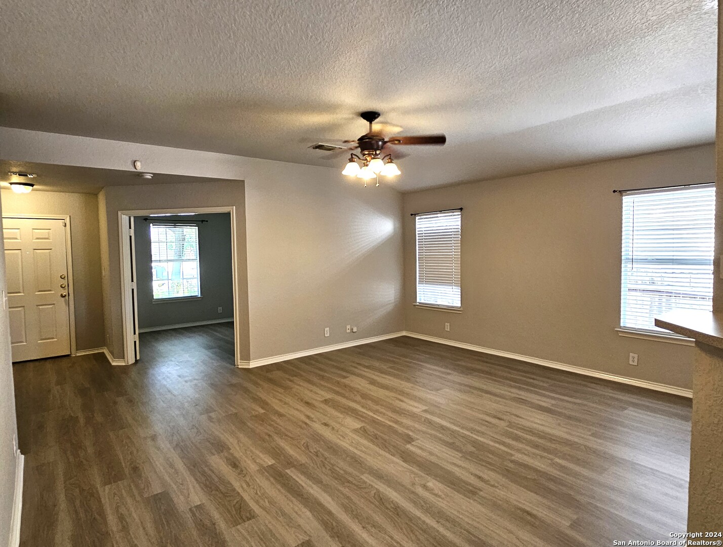 3321 Whisper Bluff Schertz, TX 78108 - Photo 5 of 17 a view of an empty room with window and wooden floor