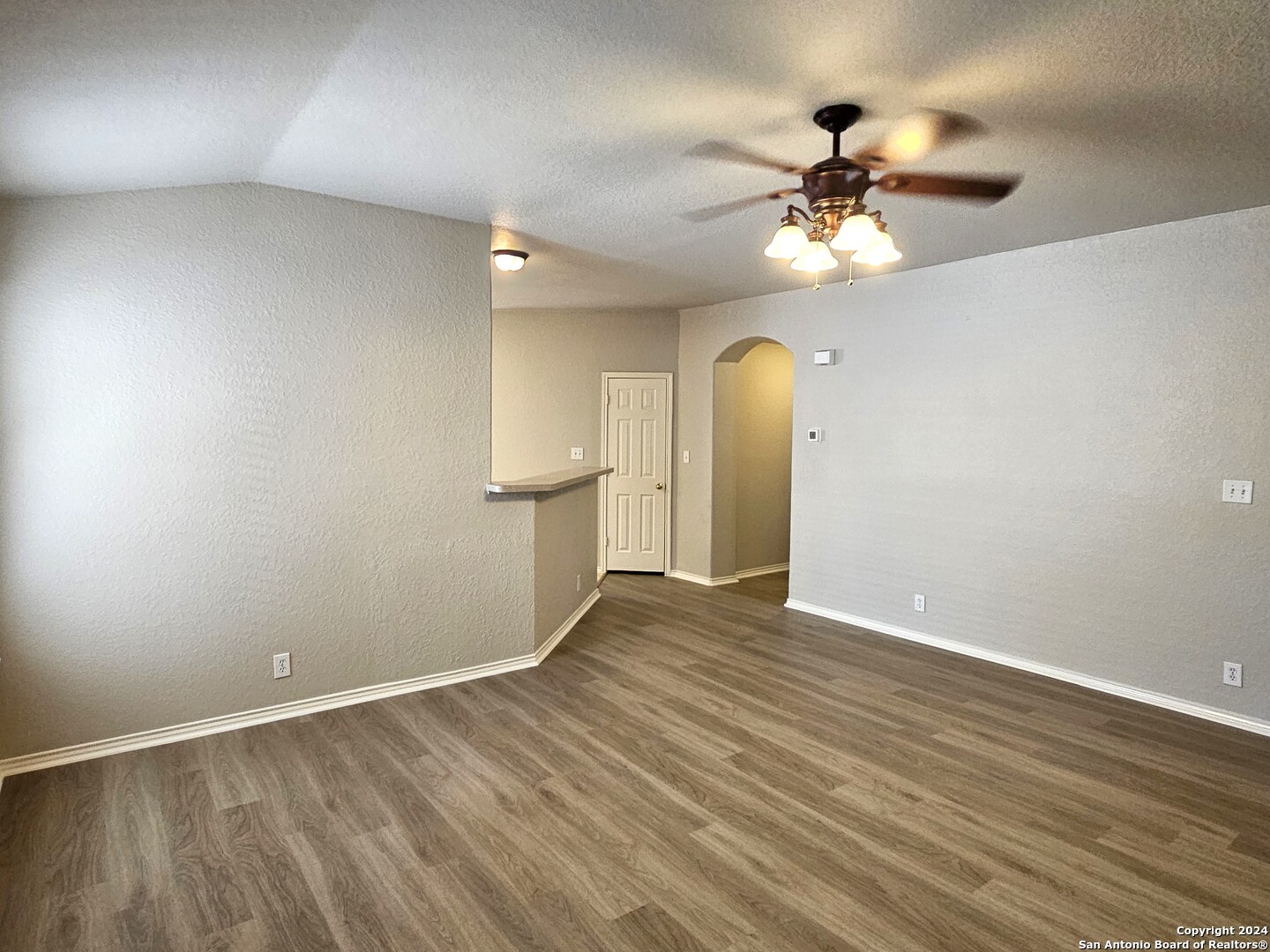 3321 Whisper Bluff Schertz, TX 78108 - Photo 7 of 17 an empty room with wooden floor fan and windows