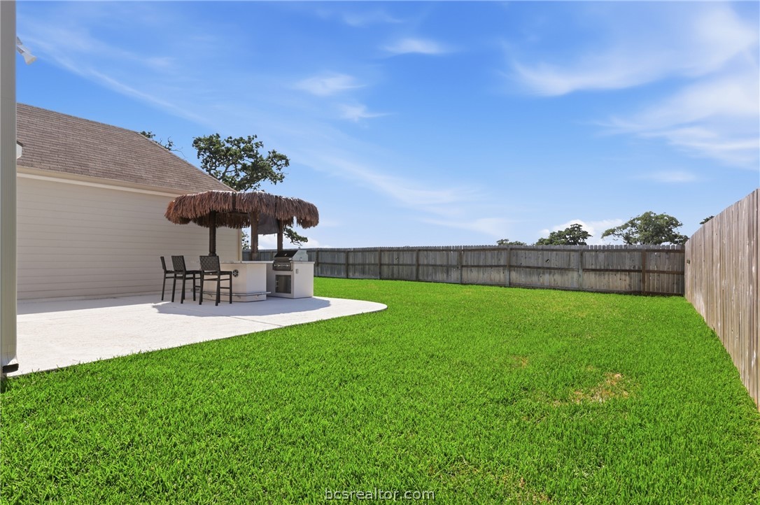 1922 Viva Road Bryan, TX 77807 - Photo 38 of 45 Expansive backyard featuring an upgraded and extended patio with cool coat decking, plus rare privacy with no back neighbors backing to a ranch.