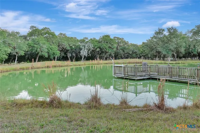 a view of a house with a patio and a car parked in it