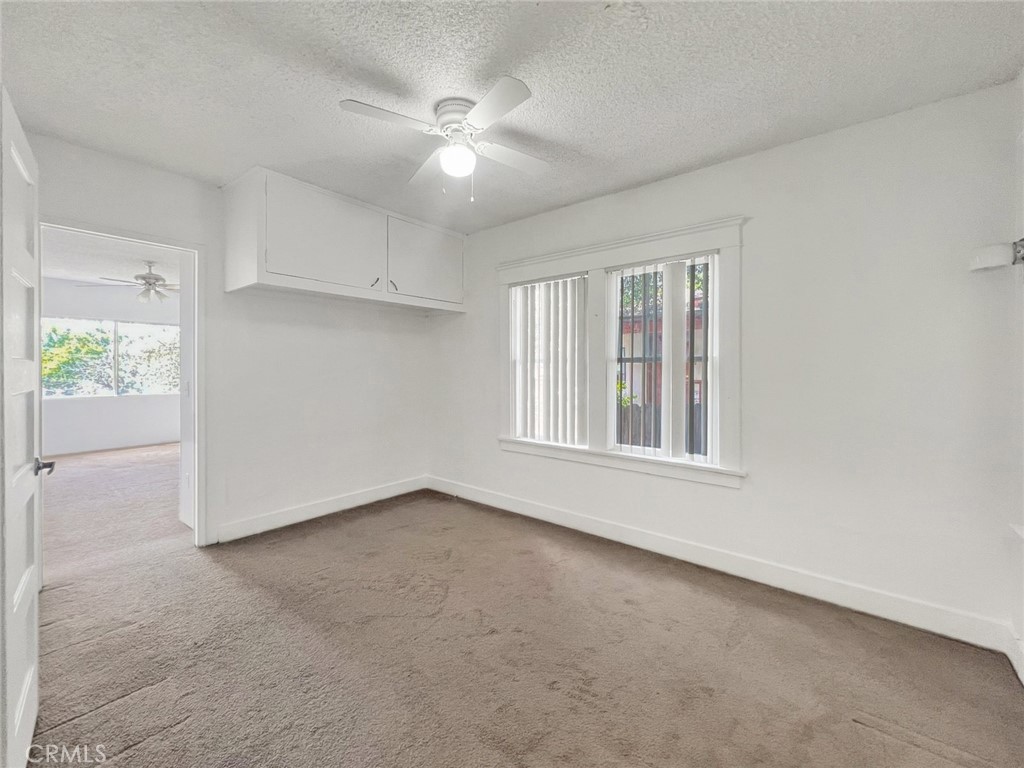 1554 East Woodbury Road Pasadena, CA 91104 - Photo 11 of 13 an empty room with a empty space and windows