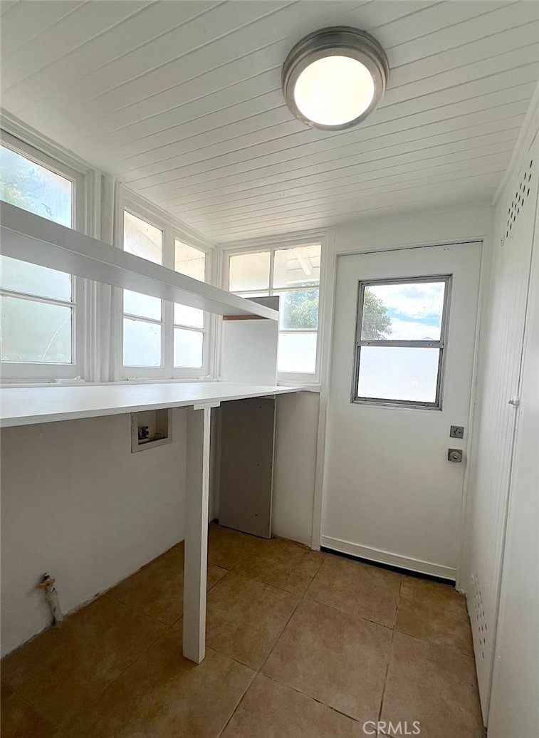 1554 East Woodbury Road Pasadena, CA 91104 - Photo 8 of 13 a view of a kitchen with an empty space and a window