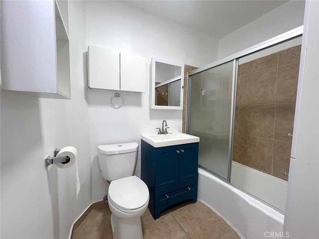 1554 East Woodbury Road Pasadena, CA 91104 - Photo 10 of 13 a bathroom with a sink toilet and shower