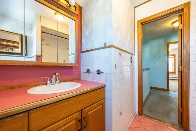 a bathroom with a sink a mirror and a shower