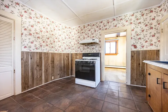 a kitchen with a stove and a refrigerator