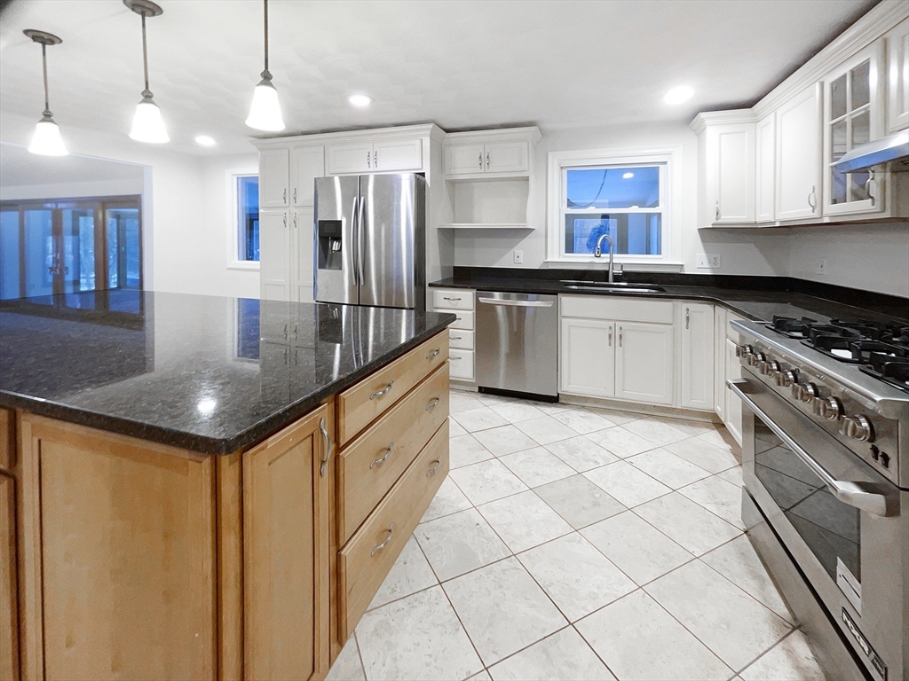 16 Marlyn Road Billerica, MA 01821 - Photo 6 of 34 a kitchen with granite countertop a sink a counter top space stainless steel appliances and cabinets