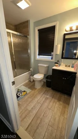 a bathroom with a sink a toilet and mirror