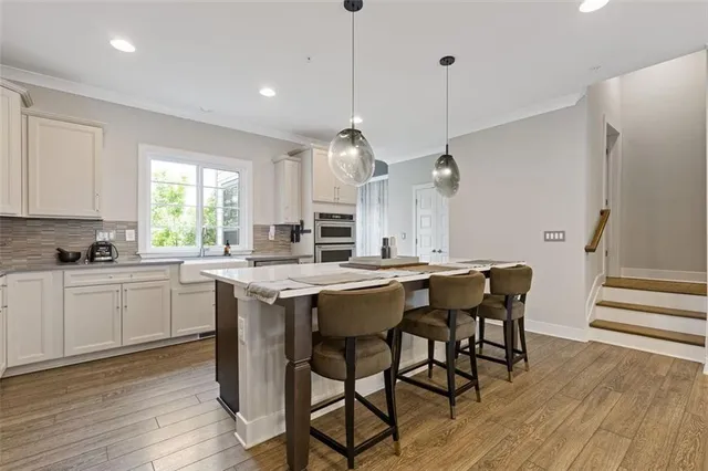 a kitchen with white cabinets and appliances
