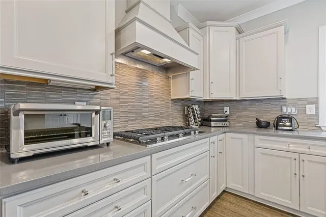 a kitchen with a sink a counter top space appliances and cabinets