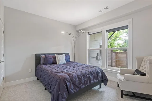 a bathroom with a granite countertop sink toilet a mirror and shower