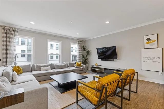 a living room with furniture and wooden floor