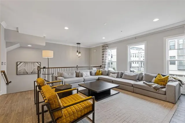 a living room with furniture and kitchen view