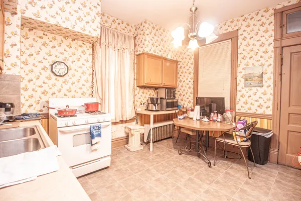 a living room with furniture a large window and a table