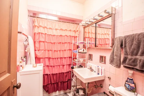 a bathroom with a sink toilet and shower curtain