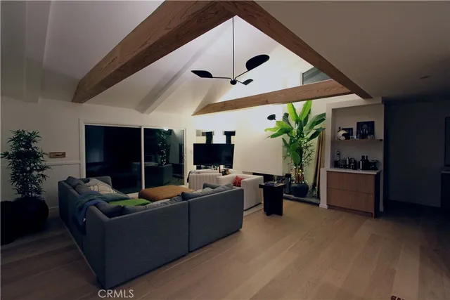 a dining room with furniture and potted plants